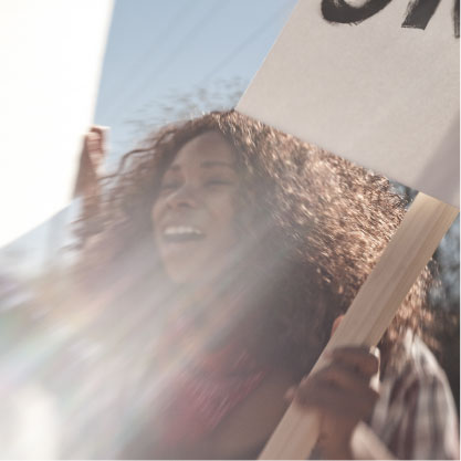 Women Protesting holding a sign