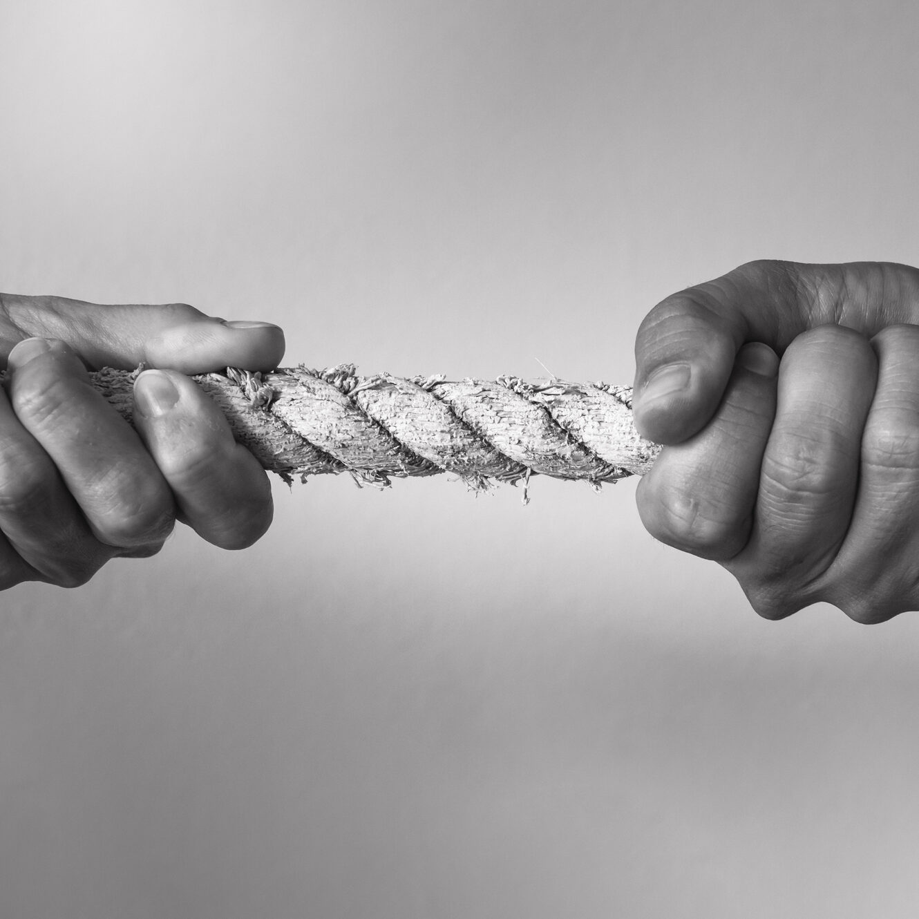 Hands pulling rope playing tug of war